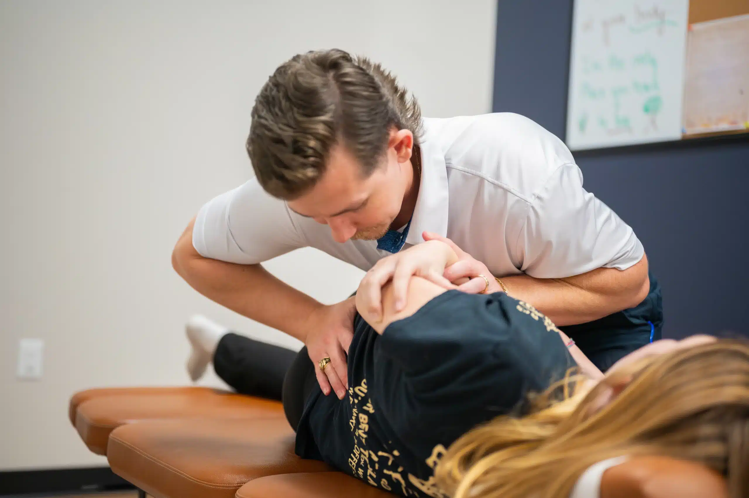Fort Worth chiropractor performing a hands-on spinal adjustment to improve alignment and mobility